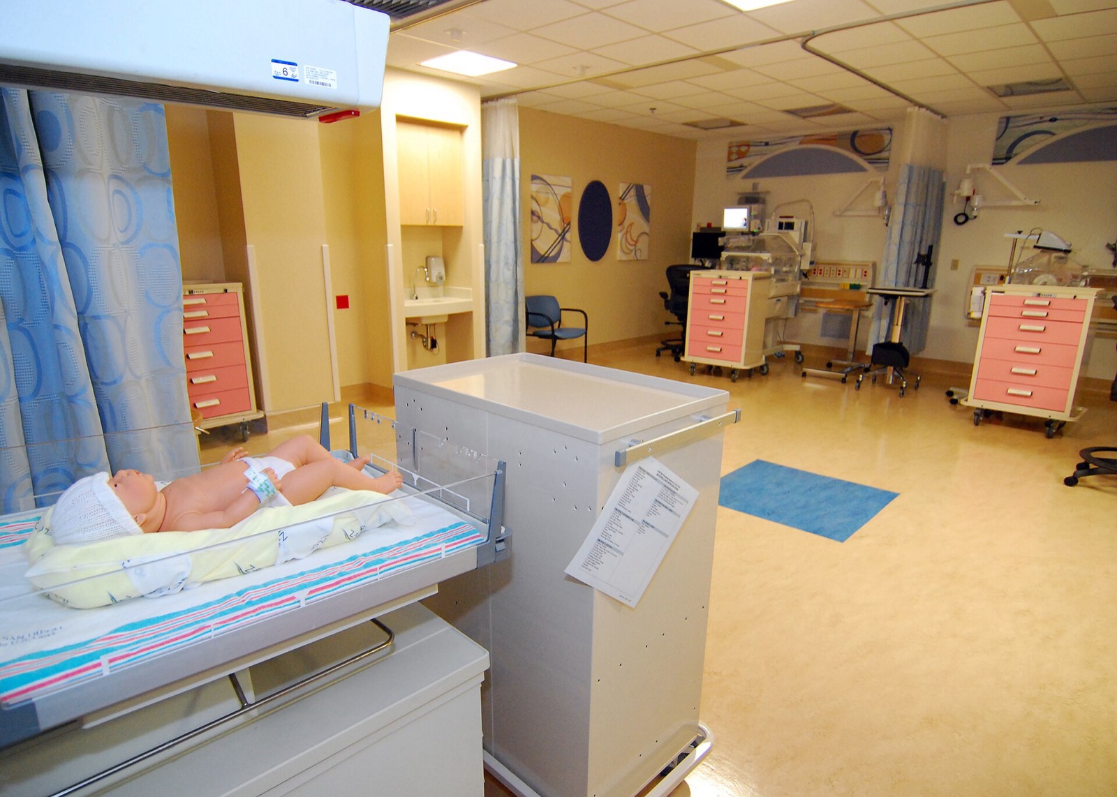 A neonatal intensive care pod with an incubator and monitoring equipment